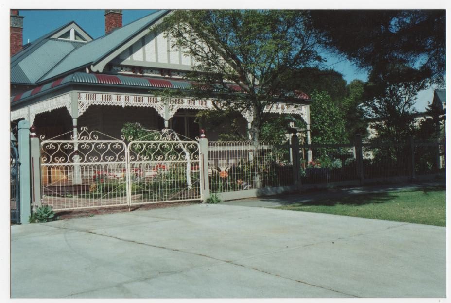 Ornate metal driveway gates with scrollwork
