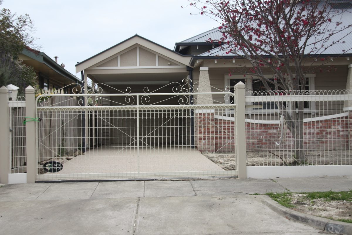 Metal driveway gate on a residential street