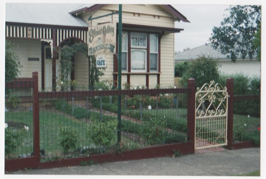 Front yard fence with wire mesh infill and metal gate panel